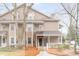 Charming two-story townhome with neutral siding, and a covered front porch at 2116 N Forest Trl, Dunwoody, GA 30338