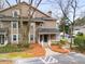 Well-maintained exterior with a covered porch and mature trees at 2116 N Forest Trl, Dunwoody, GA 30338
