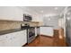 Modern kitchen with stainless steel appliances, granite countertops, and white cabinets at 2116 N Forest Trl, Dunwoody, GA 30338
