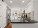 Well-lit kitchen featuring stainless steel appliances, stone countertops, and a breakfast bar at 2116 N Forest Trl, Dunwoody, GA 30338
