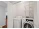 Convenient laundry room with washer, dryer, and shelving for storage at 2116 N Forest Trl, Dunwoody, GA 30338