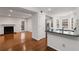 Cozy living room with fireplace flows to kitchen with breakfast bar and stainless appliances at 2116 N Forest Trl, Dunwoody, GA 30338