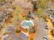 Aerial view of a community pool surrounded by mature trees and landscaping, with ample parking nearby at 2116 N Forest Trl, Dunwoody, GA 30338