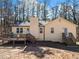 Back of house featuring a deck and stairs with lots of surrounding trees at 1885 Mountain Trace, Canton, GA 30114