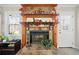 Cozy fireplace with stone surround, decorative mantel, and views of the outdoors from the nearby windows at 1885 Mountain Trace, Canton, GA 30114