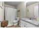 Clean bathroom featuring a shower with curtain, a toilet and a sink at 310 Indian Lake Trl, Villa Rica, GA 30180