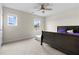 This bedroom features cozy carpet, natural light, and a ceiling fan at 310 Indian Lake Trl, Villa Rica, GA 30180