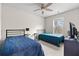 Bright bedroom offering two beds, a ceiling fan, and natural light at 310 Indian Lake Trl, Villa Rica, GA 30180