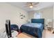 Bright bedroom with a ceiling fan, natural light, and personal touches at 310 Indian Lake Trl, Villa Rica, GA 30180