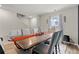 A dining room featuring a large wooden table, seating for six, and natural light from the window at 310 Indian Lake Trl, Villa Rica, GA 30180