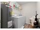 This laundry room features a water heater, washer and dryer at 310 Indian Lake Trl, Villa Rica, GA 30180