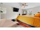This main bedroom offers a ceiling fan, TV and comfortable setting at 310 Indian Lake Trl, Villa Rica, GA 30180