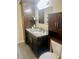 Bathroom features granite countertops, tile flooring, and dark wood cabinetry, offering a sleek design at 4567 Duncan Dr, Sugar Hill, GA 30518