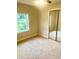 Bedroom with carpeted floors, mirrored closet doors, and natural light at 4567 Duncan Dr, Sugar Hill, GA 30518