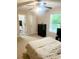 Spacious bedroom with neutral carpet, ceiling fan and an ensuite bathroom, promoting comfort at 4567 Duncan Dr, Sugar Hill, GA 30518