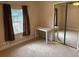 Bedroom featuring neutral carpet, double window, and a mirrored closet door at 4567 Duncan Dr, Sugar Hill, GA 30518