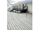 Gray wood deck overlooking the back yard with a grill and gray painted railing at 4567 Duncan Dr, Sugar Hill, GA 30518