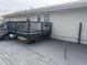 View of a spacious deck painted grey with stairs and black metal railings outside home at 4567 Duncan Dr, Sugar Hill, GA 30518