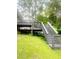 Wooden deck with stairs leading to green backyard, perfect for outdoor enjoyment at 4567 Duncan Dr, Sugar Hill, GA 30518