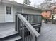 View of a spacious deck painted grey with stairs and black metal railings at 4567 Duncan Dr, Sugar Hill, GA 30518