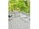 Relaxing gray deck with a table and chairs, perfect for outdoor dining at 4567 Duncan Dr, Sugar Hill, GA 30518