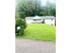 Charming single-story home with a well-maintained lawn and mature trees at 4567 Duncan Dr, Sugar Hill, GA 30518