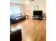 Spacious living room with hardwood floors and natural light from a large window at 4567 Duncan Dr, Sugar Hill, GA 30518