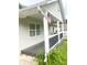 View of covered porch with black wood railing and American flag at 4567 Duncan Dr, Sugar Hill, GA 30518