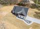 An aerial view of a newly constructed home with a paved driveway, pristine landscaping, and a well-manicured lawn at 1270 Sandhill Hulett Rd, Villa Rica, GA 30180