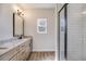 Modern bathroom with granite countertop, double vanity, and a glass-enclosed shower at 1270 Sandhill Hulett Rd, Villa Rica, GA 30180