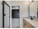 Modern bathroom featuring a glass shower, granite countertop, and access to a bedroom with paneled accent wall at 1270 Sandhill Hulett Rd, Villa Rica, GA 30180