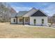 Charming one-story home with white siding, black accents, large front lawn, and a paved walkway to the front door at 1270 Sandhill Hulett Rd, Villa Rica, GA 30180