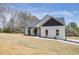 Charming one-story home with white siding, black accents, a large front lawn, and a paved walkway to the front door at 1270 Sandhill Hulett Rd, Villa Rica, GA 30180