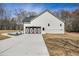Charming white home featuring decorative garage doors and a paved driveway at 1270 Sandhill Hulett Rd, Villa Rica, GA 30180