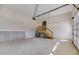 Spacious garage featuring ample storage, a wooden staircase, and an automatic door opener at 1270 Sandhill Hulett Rd, Villa Rica, GA 30180