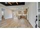 Open concept kitchen with light wood cabinets, stainless steel appliances, island, and double doors to the outside at 1270 Sandhill Hulett Rd, Villa Rica, GA 30180
