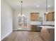 Bright kitchen with stainless steel appliances, light wood cabinets, island, and a double door leading to a deck at 1270 Sandhill Hulett Rd, Villa Rica, GA 30180