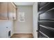 Bright laundry room with light wood cabinets and plenty of space for folding and storage at 1270 Sandhill Hulett Rd, Villa Rica, GA 30180