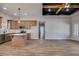 Open-concept living space featuring a modern kitchen island, hardwood flooring, and lots of natural light at 1270 Sandhill Hulett Rd, Villa Rica, GA 30180