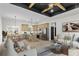 Open concept living room and kitchen with wooden beams, stainless steel appliances, and modern furniture at 1270 Sandhill Hulett Rd, Villa Rica, GA 30180