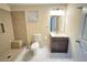 Bathroom with vanity, toilet, and a shower featuring tiled walls at 24 Moreland Ne Ave, Atlanta, GA 30307