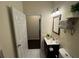 Bathroom featuring modern lighting, a vanity, and towel storage on shelves at 24 Moreland Ne Ave, Atlanta, GA 30307