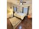 Cozy bedroom featuring a comfortable queen-size bed, soft decor, and ample natural light from two windows at 24 Moreland Ne Ave, Atlanta, GA 30307