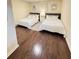 Bedroom with two beds, nightstand, hardwood floors, and decor art at 24 Moreland Ne Ave, Atlanta, GA 30307
