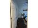 Hallway leading to a bedroom featuring hardwood floors, a lamp, and artwork at 24 Moreland Ne Ave, Atlanta, GA 30307