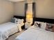 Bedroom featuring two beds, carpet, lamps and natural light at 24 Moreland Ne Ave, Atlanta, GA 30307