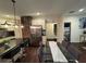 Open-concept area with a dining table, kitchen island seating, and stainless steel appliances for modern living at 24 Moreland Ne Ave, Atlanta, GA 30307