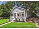Charming bungalow with a welcoming front porch, landscaped yard, and a striking red front door at 24 Moreland Ne Ave, Atlanta, GA 30307