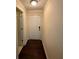 Bright hallway featuring dark wood flooring and a white entry door at 24 Moreland Ne Ave, Atlanta, GA 30307