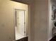Hallway view to bathroom featuring a partial view of the shower and marble-look floors at 24 Moreland Ne Ave, Atlanta, GA 30307